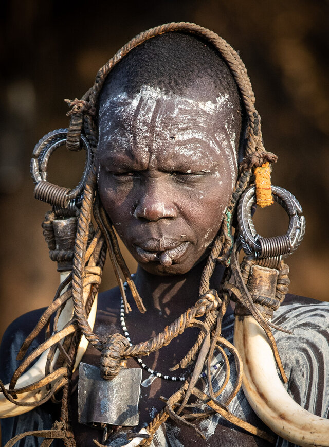 A close-up of a Suri man with intricate headgear and facial markings, symbolizing cultural pride and identity. (Credit: Jayne Mclean) 