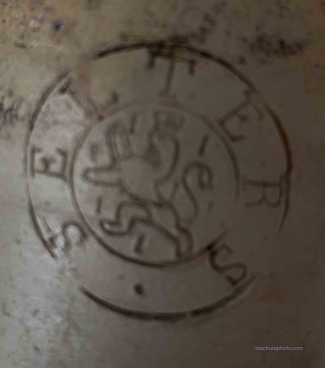 A close-up of the ship's maker's mark seal, featuring a lion emblem surrounded by text, offering a vital clue to its origins.