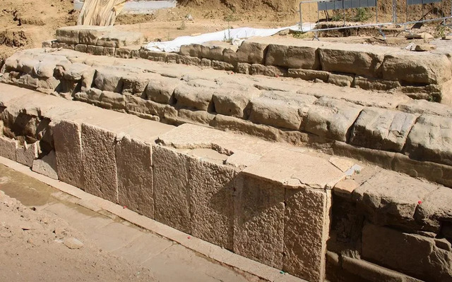 A close-up of the temple’s foundation, featuring horizontal sandstone blocks and marble slabs that highlight the structure’s architectural grandeur.