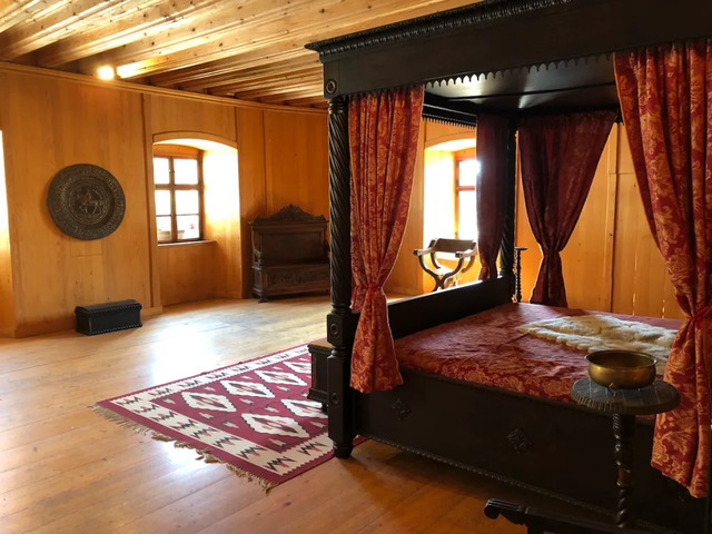 A cozy bedroom tucked within Predjama Castle highlights the more domestic side of fortress life. (Photo: Joan Sherman)