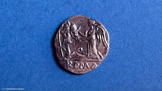 A detailed image of a Roman coin with engravings that honor historical events and figures, found at Claterna.