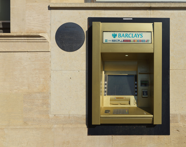 A golden cash machine and commemorative plaque celebrate the 50th anniversary of the world’s first ATM. © Historic England Archive DP434089.