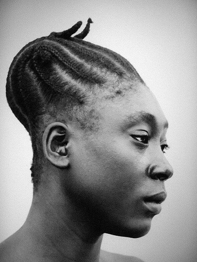 A close-up of a Mangbetu woman showcasing the intricate hairstyle designed to emphasize the elongated shape of the head, a cultural ideal of beauty and status.