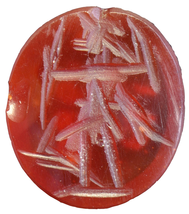 A magnified view of the carnelian gemstone, revealing the engraving details of Diana drawing her bow, an exquisite example of Roman artistry.