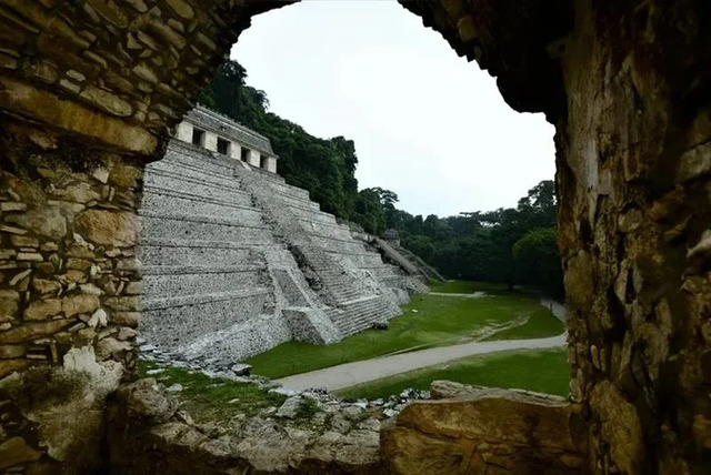 A picturesque view through the ancient structures of Chichén Itzá, revealing the grandeur of this Maya city. Credit: INAH