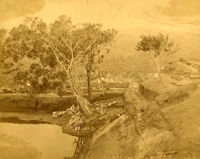 A rare historical image of the excavation work revealing the ruins of Sigiriya’s Upper Palace, including water pools and structural remains.