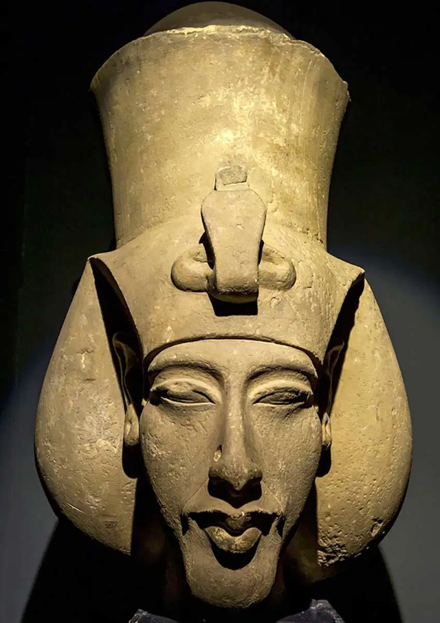 A striking bust of Akhenaten from the Alexandria National Museum, showcasing the unique artistry of the Amarna period. (Source: Encyclopedia Britannica)