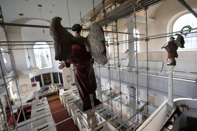 A view of the angels atop columns in the nave of Old North Church, amidst scaffolding during the restoration process.