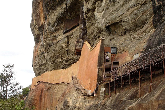 A walkway along the rock face of Sigiriya, famously known as the "Mirror Wall," which once reflected the images of ancient visitors and leads to the iconic frescoes.