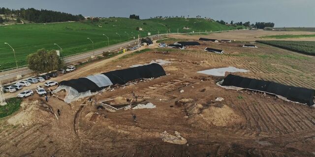 A wide shot of the excavation site revealing the systematic approach taken by archaeologists to uncover the remains of the Roman legionary base.