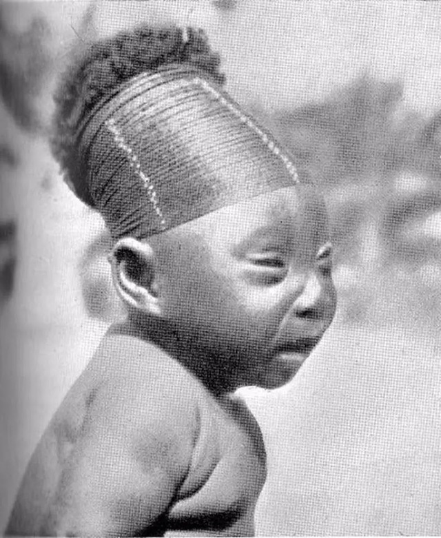 A Mangbetu infant with their head wrapped to achieve the elongated shape. The practice of Lipombo begins shortly after birth and continues for several years.