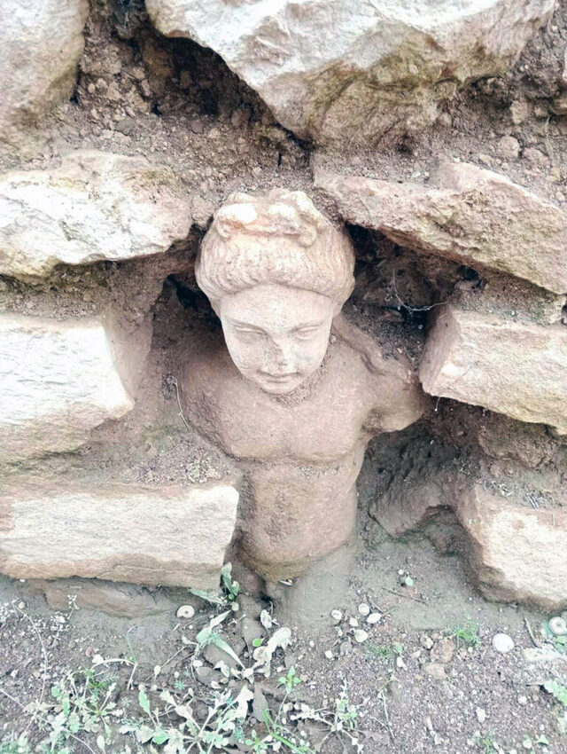 Among the most captivating discoveries is an embedded statue of a youthful male figure, unearthed during the installation of a fire safety network in the archaeological site