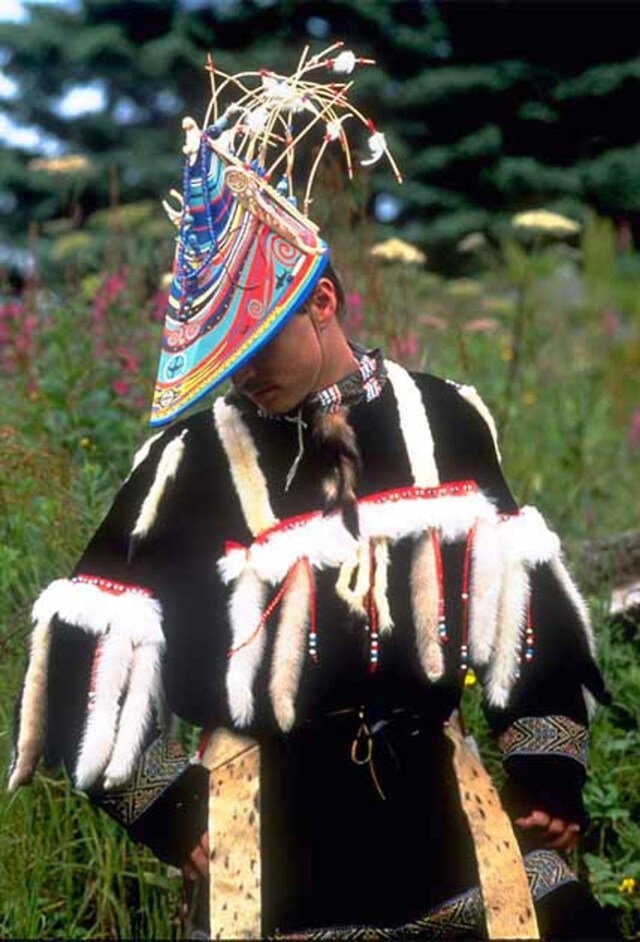 An Alutiiq dancer adorned in traditional artisanal attire and a handcrafted hat performs at the biennial "Celebration" cultural event, showcasing the richness of their heritage. (Public Domain)