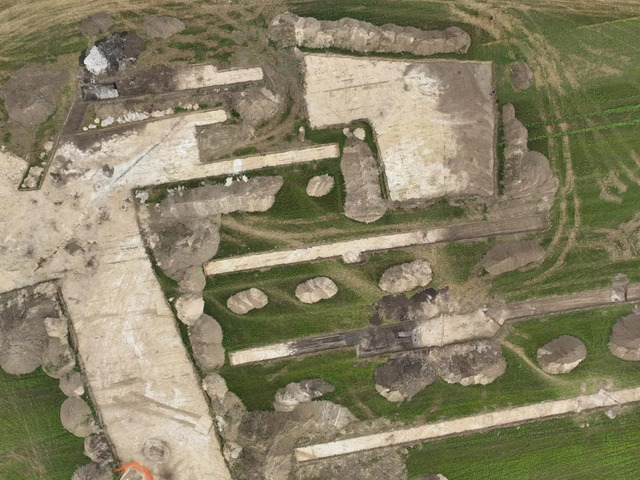 An aerial view of the archaeological site reveals the layout of the Neolithic village, including sections of the palisade and various structures. (Credit: CNRS)