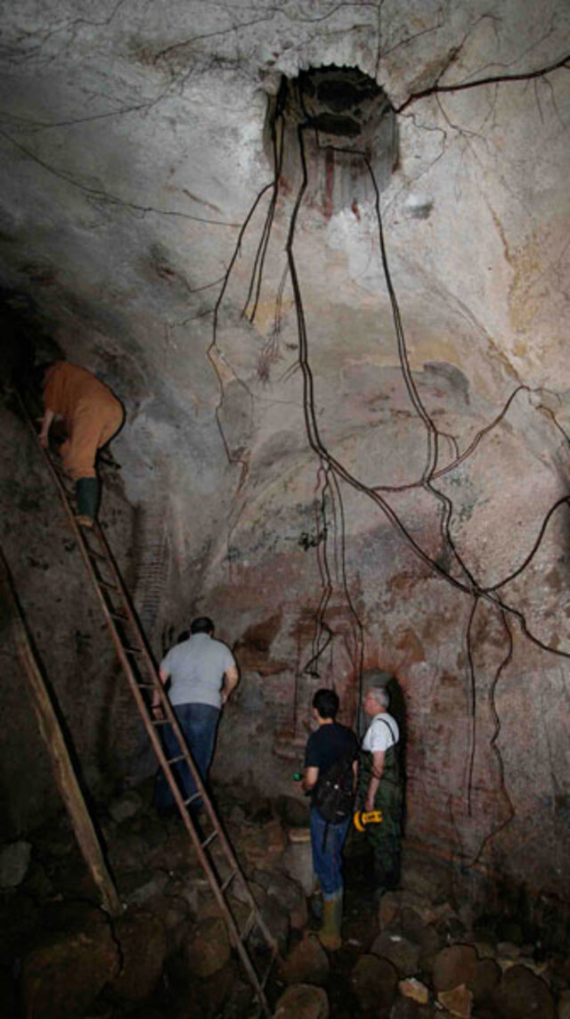 An arch leading to the right-hand chamber of the Santa Fiora springhouse has been sealed off, leaving only a narrow entrance near its upper edge.