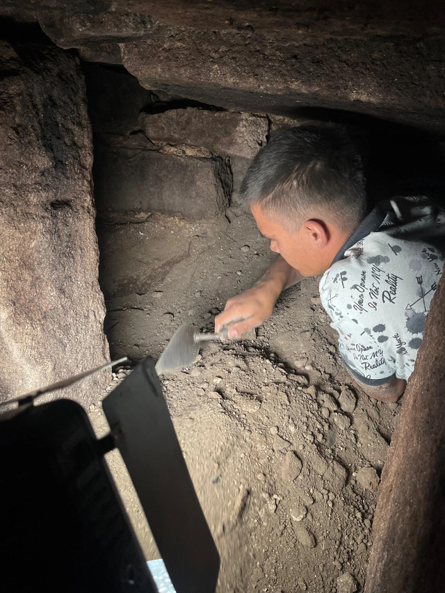 An archaeologist carefully unearths artifacts and layers of history inside the Ottoman-era bath site in Assos.