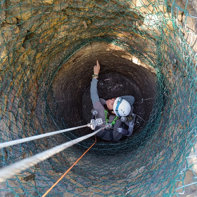 Archaeologist Esperanza Martín descends into the ancient Roman well using a pulley system to recover historical artifacts while minimizing damage.