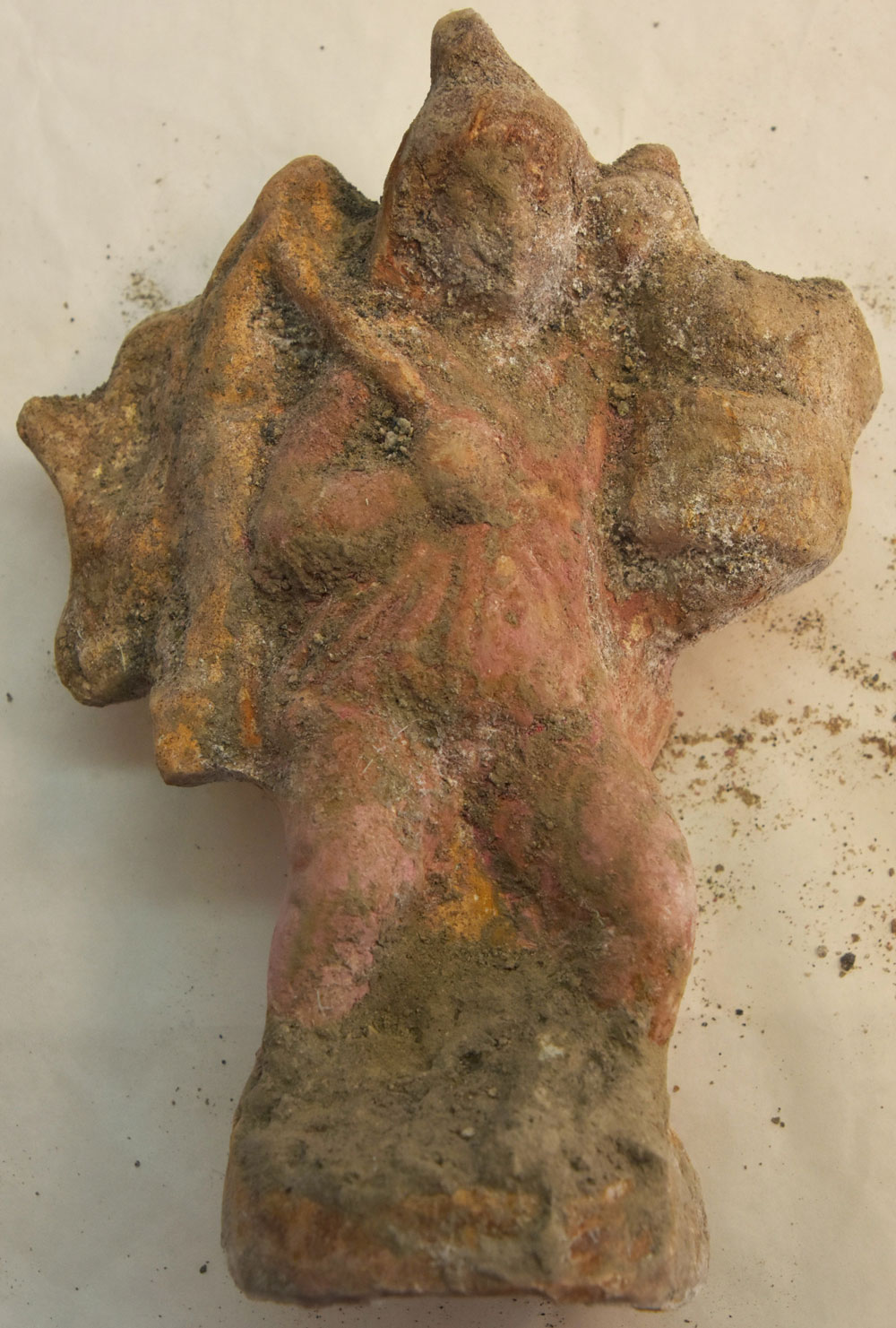 A terracotta figurine of a deity or mythological character, adorned with vivid traces of pigment, showcasing the artistic detail and cultural importance of these artifacts.