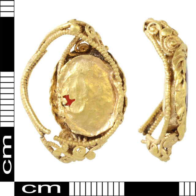 Back view of the intaglio ring, illustrating the triangular structure and beaded gold patterns, with visible wear reflecting its ancient use.