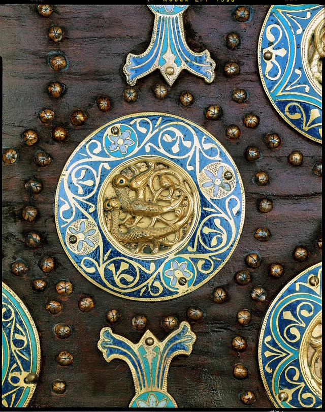 Close-up of a medallion on the Limoges casket, featuring a pair of mythical creatures surrounded by enamel floral designs. This decorative motif illustrates the fusion of medieval fantasy and technical mastery. (Source: Museum records)