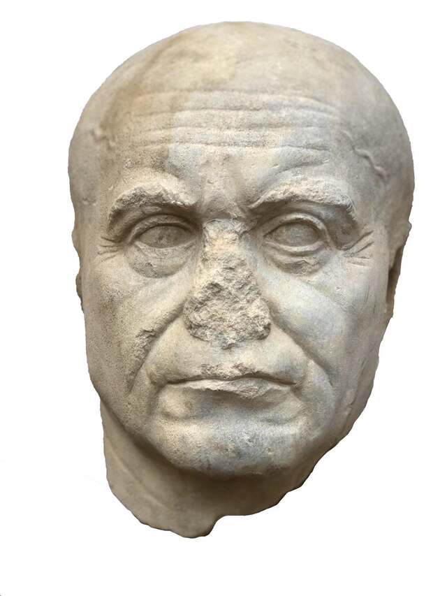 Carved with high precision, the head depicts an elderly, bald man with wrinkles and a stern expression