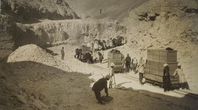 Howard Carter and his team meticulously removing artifacts from Tutankhamun's tomb in the Valley of the Kings.