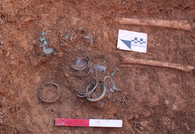 In another grave within the same cemetery, archaeologists uncovered silver earrings, nine copper-alloy bracelets, and three copper-alloy rings, showcasing the intricate craftsmanship of the time. (Credit: Headland Archaeology)