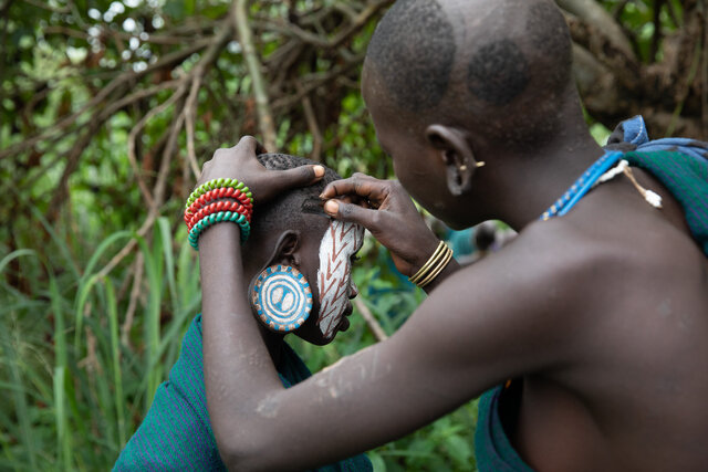 In the Suri and Mursi Tribes, hair is considered unclean, so both men and women keep it closely cropped. Razors are used to craft intricate patterns and designs, adding a personal touch to their hairstyles. (Credit: Jayne Mclean) 