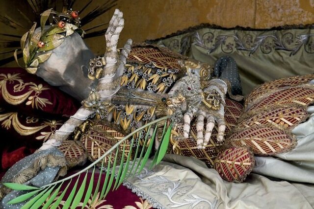 In Stams, Austria, St. Vincentus displays exposed ribs beneath a delicate lattice of golden leaves, while the hand raised to the face conveys an air of modesty. (Copyright: Paul Koudounaris)