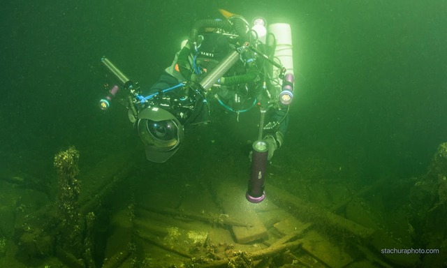 One of the Polish divers examines the sunken vessel, which carried an intriguing cargo of mineral water, porcelain, and champagne. (Photograph: Tomasz Stachura/Baltictech)