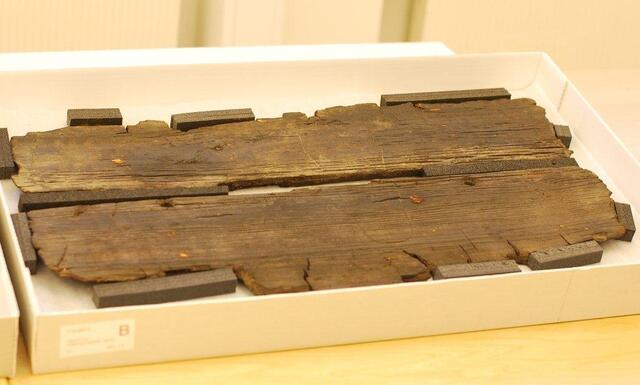 Preserved planks from the Gokstad Ship, featuring the carved outline of a Viking foot, believed to be a sign of leisure or boredom during sea voyages.