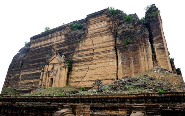 Side view of Mingun Pahtodawgyi's monumental structure, showcasing the immense scale and cracks caused by past earthquakes.