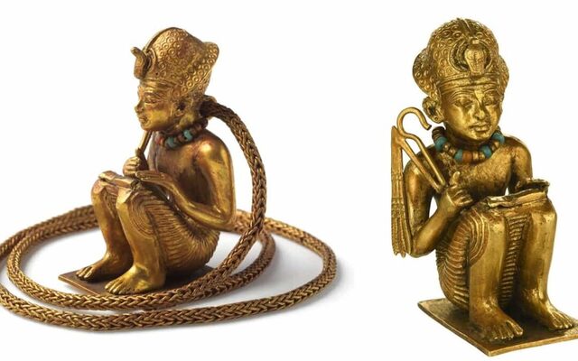 Standing just over 5 cm tall, the intricately detailed figure hangs on a substantial, intricately woven gold chain.