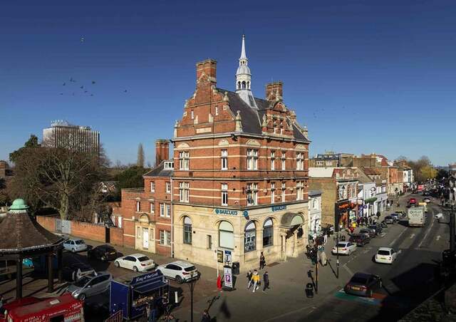 The Barclays Bank building at 20 The Town, Enfield, now recognized as a Grade II listed landmark. © Historic England Archive DP434079.