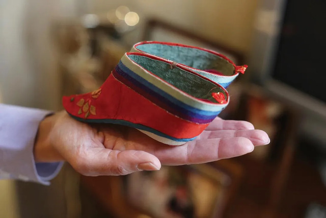 A pair of tiny "lotus shoes," once common before foot-binding was banned. (Credit: Andrew Lichtenstein)