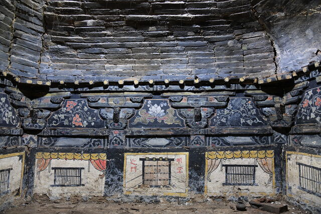 The central chamber of a Ming Dynasty tomb with detailed murals and symbolic imagery of windows and architectural features.