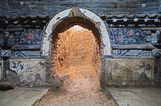 The entrance to a Ming Dynasty tomb, featuring brickwork and murals that reflect the craftsmanship of the period.