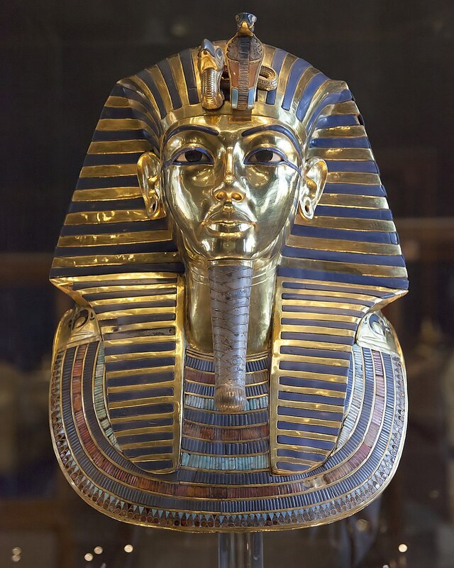 The iconic Mask of Tutankhamun on display at the Egyptian Museum in Cairo. The mask epitomizes ancient Egyptian artistry and has become a global symbol of their civilization.