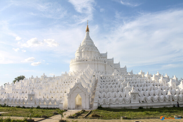 The iconic white Hsinbyume Pagoda near Mingun Pahtodawgyi, a striking contrast with its intricate wavy design symbolizing Buddhist cosmology.