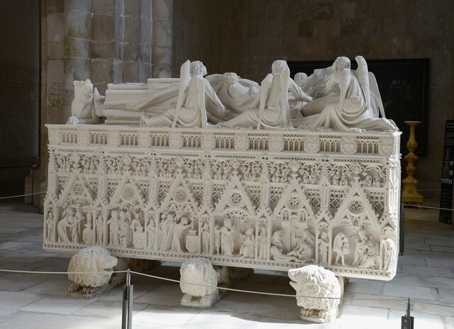 The intricately carved tomb of King Pedro I, symbolizing eternal love and justice, situated in the monastery's church.