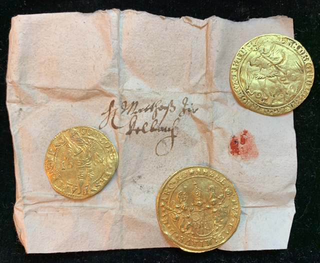 The precious gold coins were found carefully wrapped in paper, preserving their brilliance through the centuries.