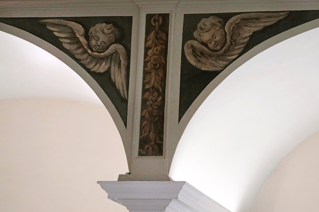 The restored cherubic figures on the arches of Old North Church’s nave, showcasing the vibrant colonial art style.