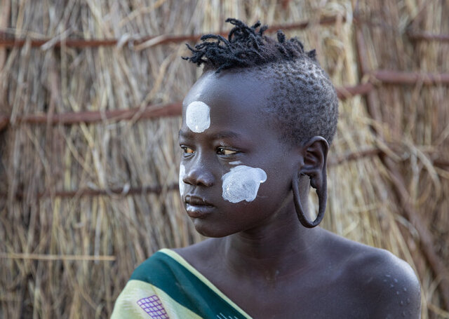 The tradition of wearing a lip plate is a personal choice for young girls, and many in the younger generation are opting to move away from this practice. (Credit: Jayne Mclean) 