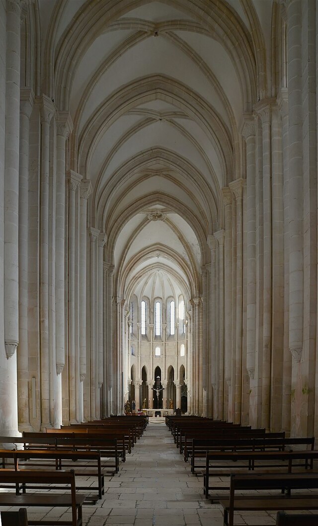 The vast Gothic nave of the Alcobaça Monastery church, showcasing its grandeur and simplicity, characteristic of Cistercian architecture.