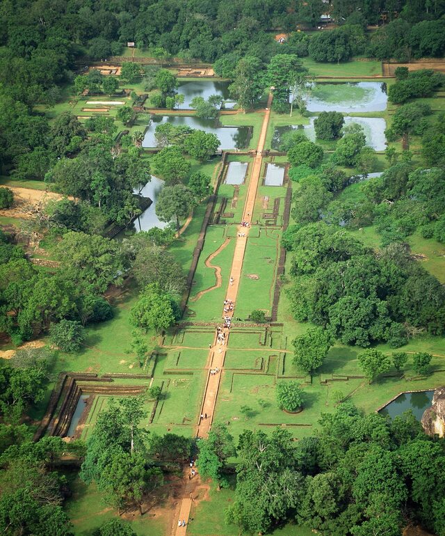 The western esplanade garden at Sigiriya showcases a striking contrast, blending precise rectilinear designs with the organic curves of the surrounding natural greenery.