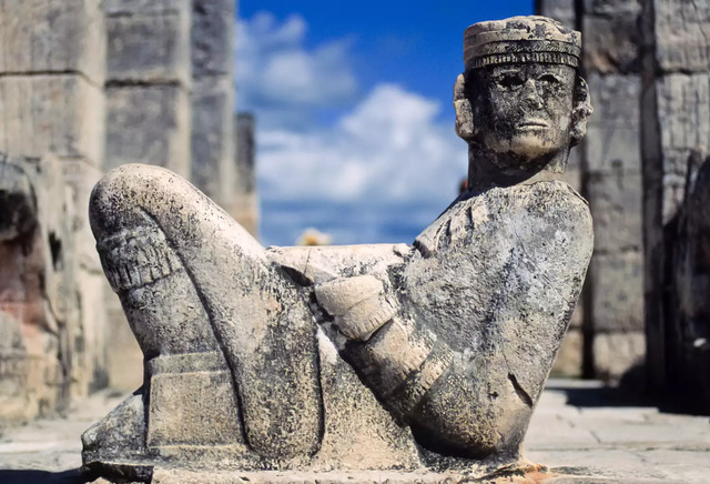 This image shows a prominent Chac Mool statue, a hallmark of Mesoamerican archaeology, located in the Temple of Warriors at Chichen Itza, Yucatan, Mexico. 