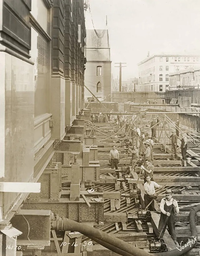 To support the immense weight of the building, 75-ton spruce beams were strategically positioned beneath the rollers