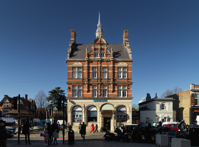 Topped with a decorative cupola and a small spire, the structure stands out as a masterpiece of late 19th-century commercial architecture