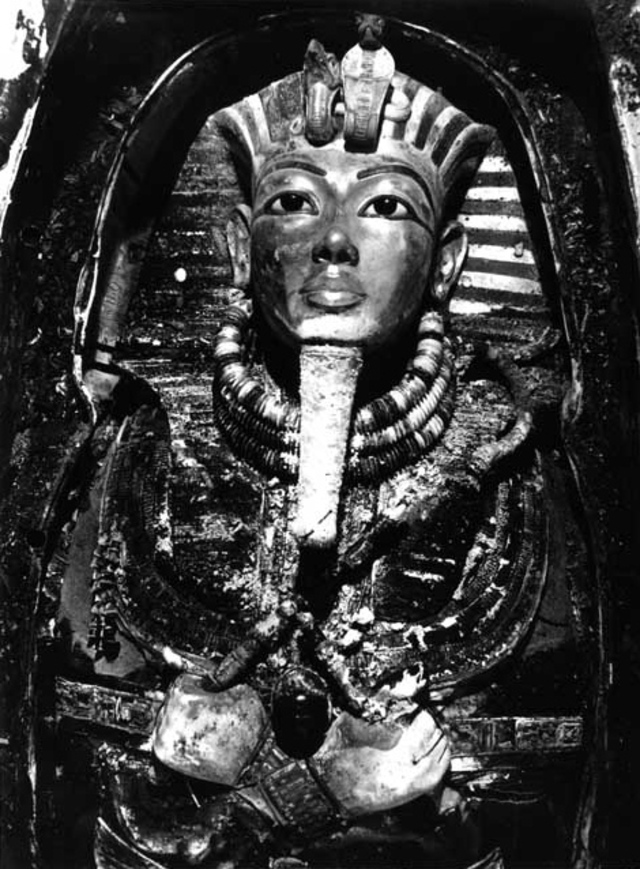 Tutankhamun's mummy adorned with the golden death mask, as discovered in his tomb in 1925 by Howard Carter's team.