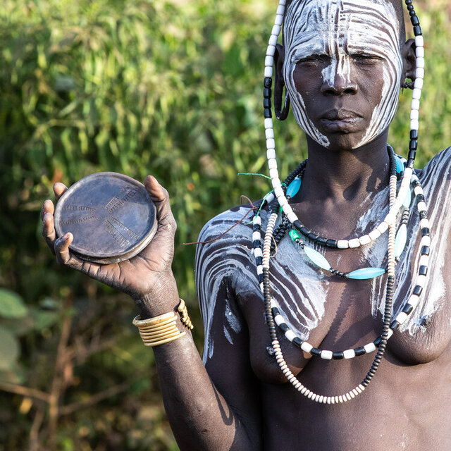 While men deeply value the cultural significance of the lip plate, many respect the girls' autonomy in deciding whether to continue the tradition. (Credit: Jayne Mclean) 